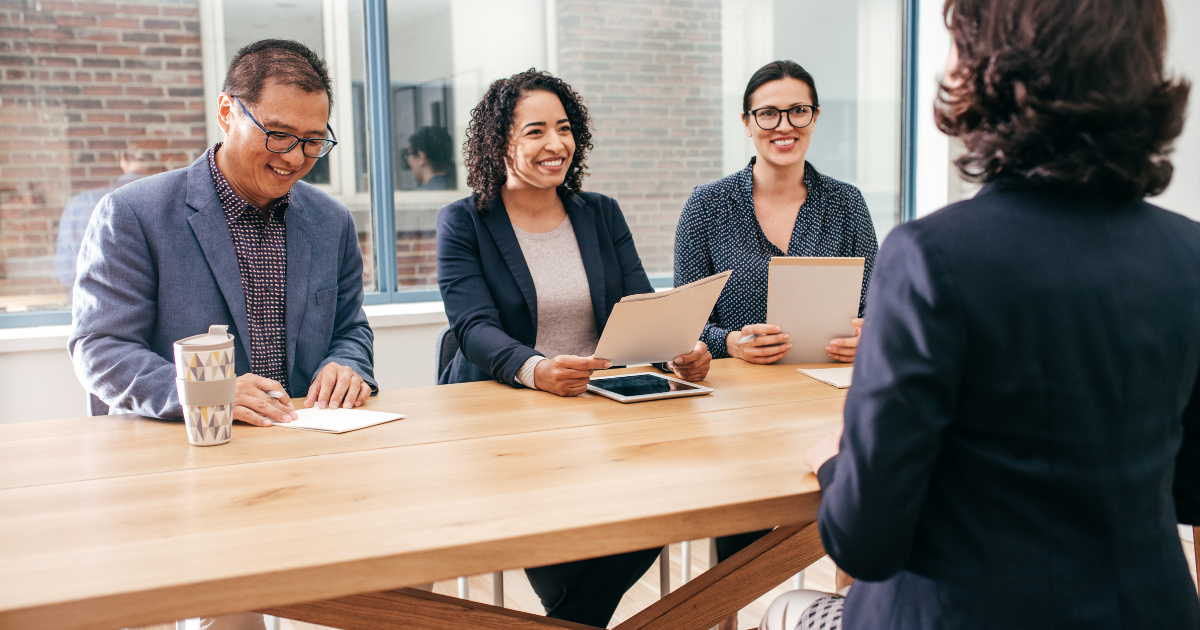 Team of recruiters sitting in an interview with a candidate